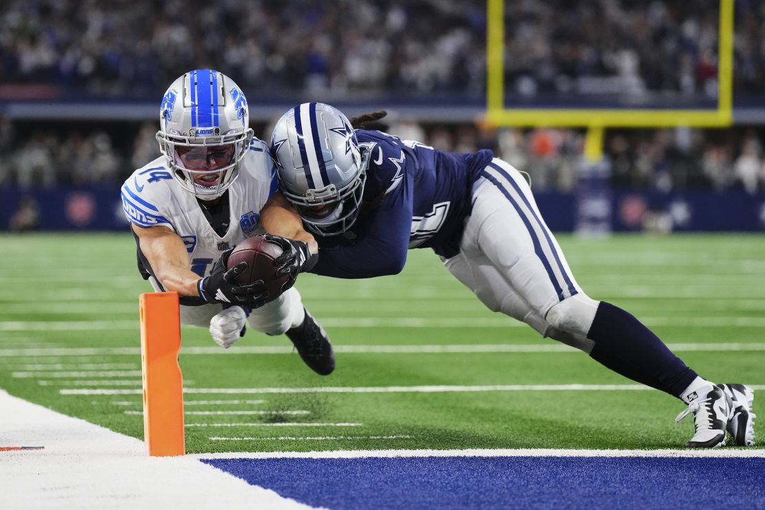 ARLINGTON, TX - DECEMBER 30: Amon-Ra St. Brown #14 of the Detroit Lions scores a touchdown against the Dallas Cowboys during the second half at AT&T Stadium on December 30, 2023 in Arlington, Texas. (Photo by Cooper Neill/Getty Images)