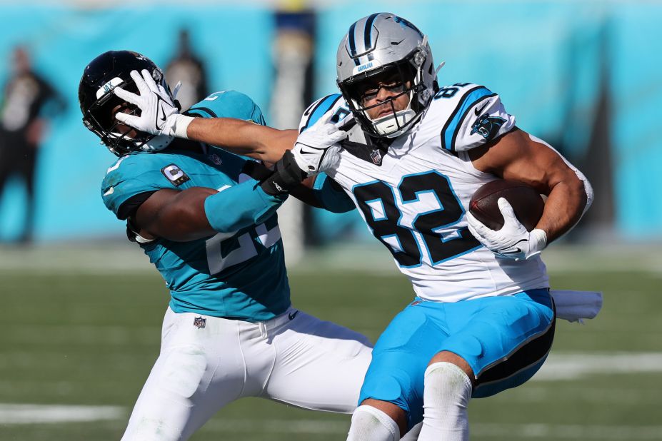 Tommy Tremble of the Carolina Panthers stiff arms Foyesade Oluokun of the Jacksonville Jaguars during the Panthers' 26-0 loss.