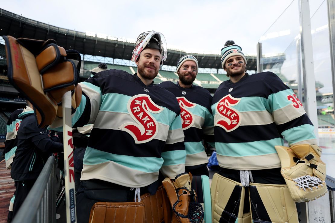 SEATTLE, WASHINGTON - DECEMBER 31: Philipp Grubauer #31, Chris Driedger #60 and Joey Daccord #35 of the Seattle Kraken pose for a photo during practice before the Discover NHL Winter Classic at T-Mobile Park on December 31, 2023 in Seattle, Washington. (Photo by Steph Chambers/Getty Images)