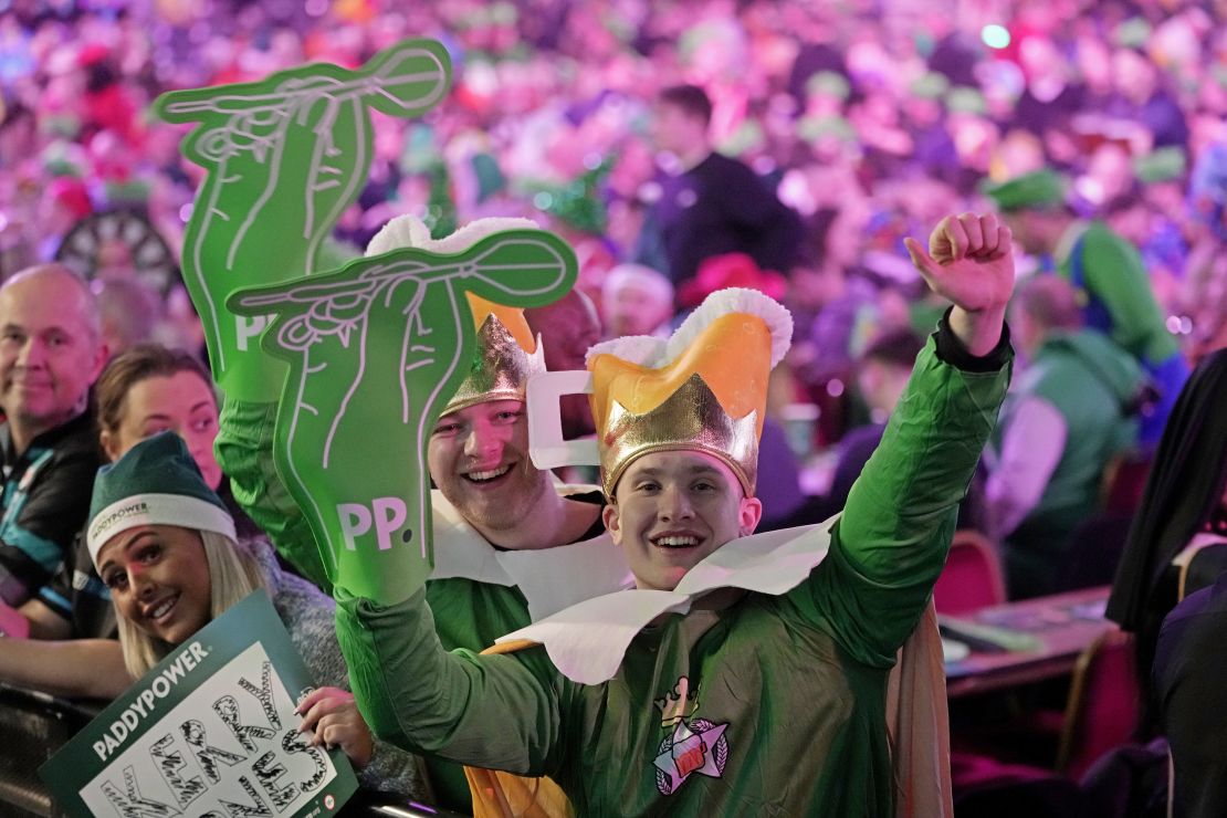 Fans celebrate at the World Darts Championship, in London, Monday, Jan. 1, 2024. (AP Photo/Kin Cheung)