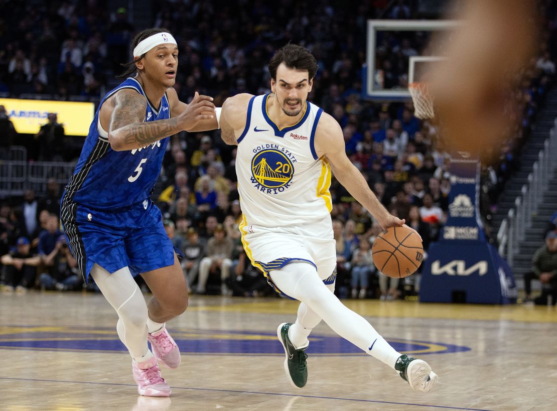 Jan 2, 2024; San Francisco, California, USA; Golden State Warriors center Dario Saric (20) drives past Orlando Magic forward Paolo Banchero (5) during the third quarter at Chase Center. Mandatory Credit: D. Ross Cameron-USA TODAY Sports