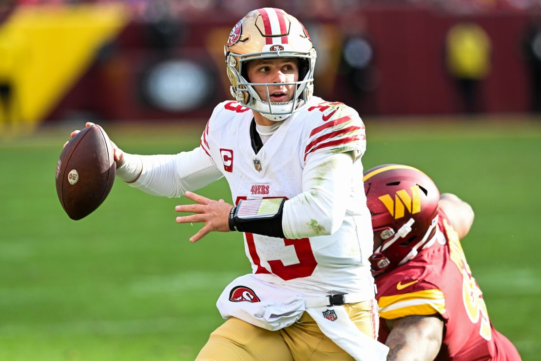 LANDOVER, MARYLAND - DECEMBER 31: Brock Purdy #13 of the San Francisco 49ers looks to pass under pressure during the second quarter of a game against the Washington Commanders at FedExField on December 31, 2023 in Landover, Maryland. (Photo by Greg Fiume/Getty Images)