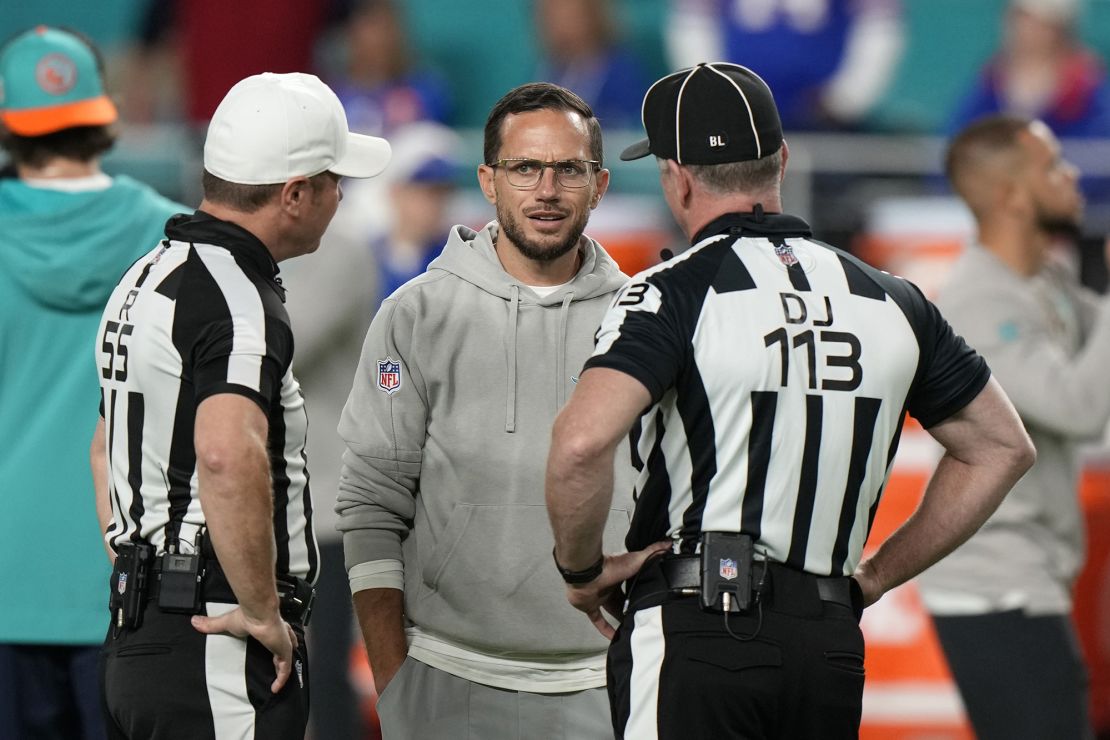 Miami Dolphins head coach Mike McDaniel talks to down judge Danny Short (113) and referee Alex Kemp (55) before an NFL football game against the Buffalo Bills, Sunday, Jan. 7, 2024, in Miami Gardens, Fla. (AP Photo/Wilfredo Lee)