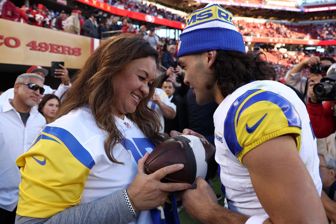 SANTA CLARA, CALIFORNIA - JANUARY 07: Puka Nacua #17 of the Los Angeles Rams hands the record breaking ball to Penina Nacua, after breaking the rookie total receiving yards in a season record at Levi's Stadium on January 07, 2024 in Santa Clara, California. (Photo by Ezra Shaw/Getty Images)