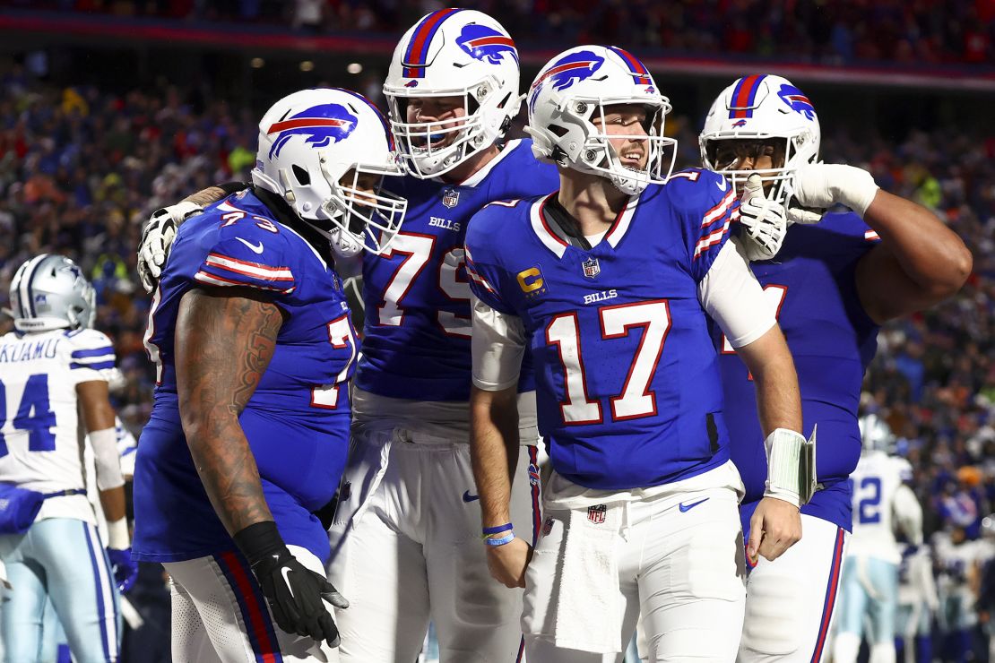 Buffalo Bills quarterback Josh Allen (17) celebrates with teammates after scoring a touchdown against the Dallas Cowboys during the second quarter of an NFL football game, Sunday, Dec. 17, 2023, in Orchard Park, N.Y. (AP Photo/Jeffrey T. Barnes)