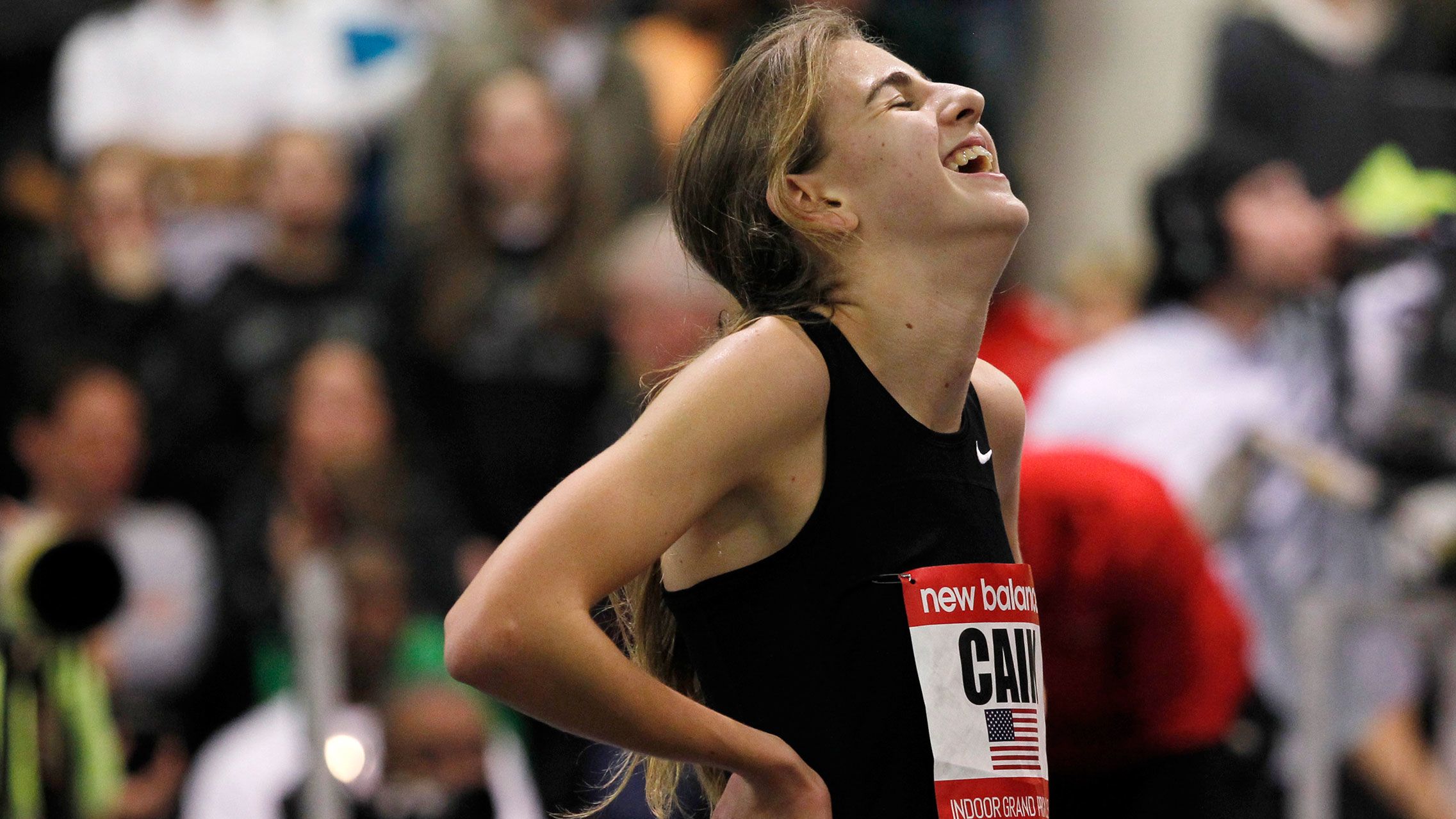 Mary Cain reacts after breaking the high school girls' record during the women's two mile event at the New Balance Indoor Grand Prix track meet in 2013.