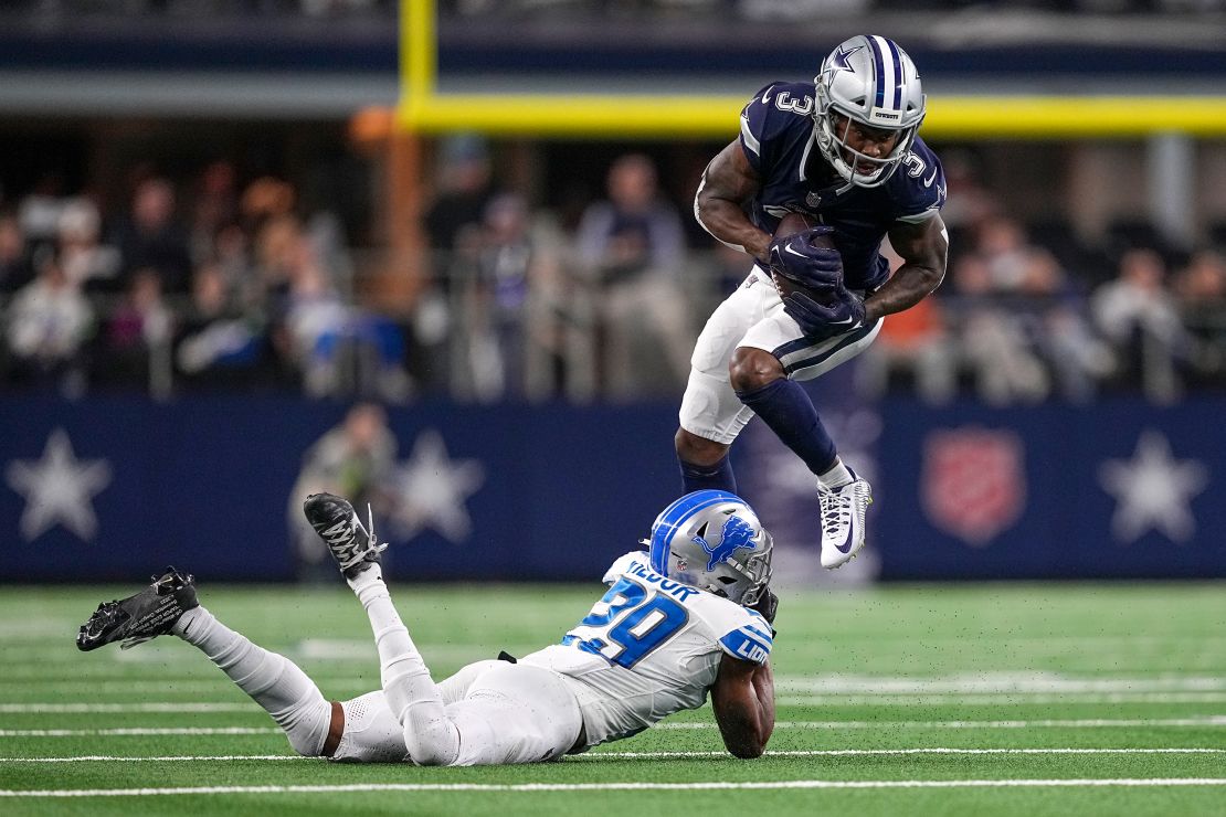 Dallas Cowboys wide receiver Brandin Cooks (3) tries to avoid a tackle by Detroit Lions cornerback Kindle Vildor (29) during the second half of an NFL football game, Saturday, Dec. 30, 2023, in Arlington, Texas.