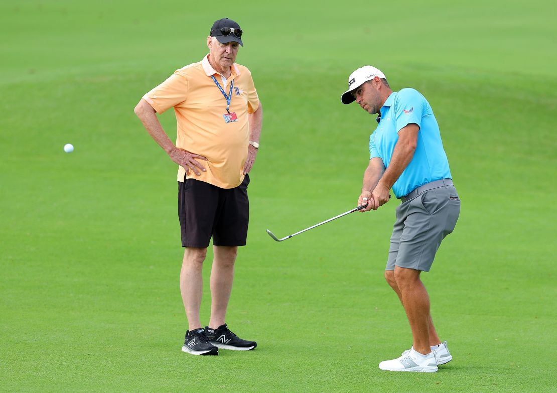 HONOLULU, HAWAII - JANUARY 09:  Gary Woodland of the United States chips on the 10th hole with Andy North during a practice round prior to the Sony Open in Hawaii at Waialae Country Club on January 09, 2024 in Honolulu, Hawaii. (Photo by Kevin C. Cox/Getty Images)