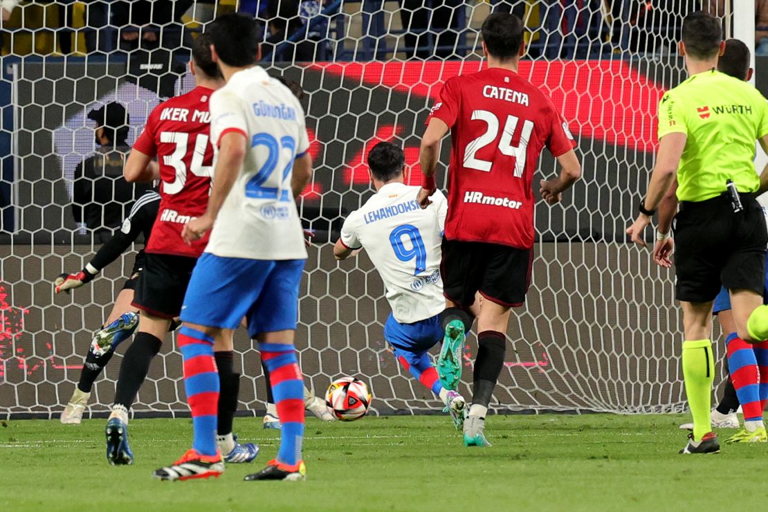 Barcelona's Polish forward #09 Robert Lewandowski shoots to score his team's first goal during the Spanish Super Cup semi-final football match between Barcelona and Osasuna at the Al-Awwal Park Stadium in Riyadh, on January 11, 2024. (Photo by Giuseppe CACACE / AFP) (Photo by GIUSEPPE CACACE/AFP via Getty Images)