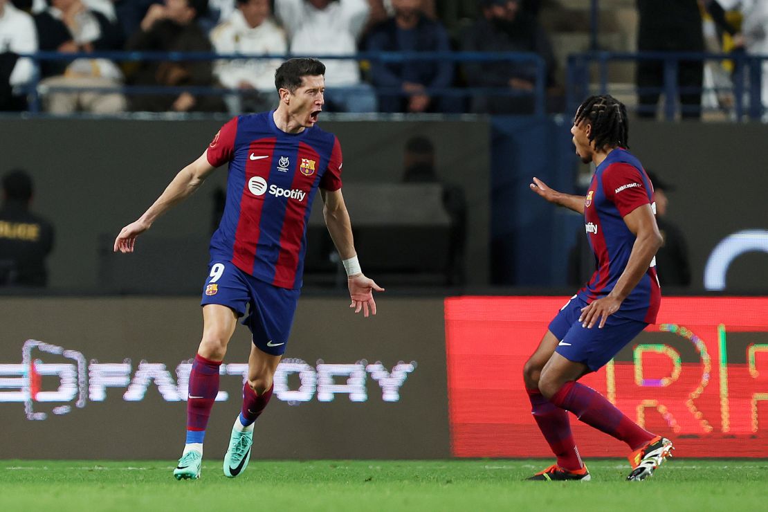 RIYADH, SAUDI ARABIA - JANUARY 14: Robert Lewandowski of FC Barcelona celebrates with teammate Jules Kounde after scoring their team's first goal during the Super Copa de España Final match between Real Madrid and FC Barcelona on January 14, 2024 in Riyadh, Saudi Arabia. (Photo by Yasser Bakhsh/Getty Images)