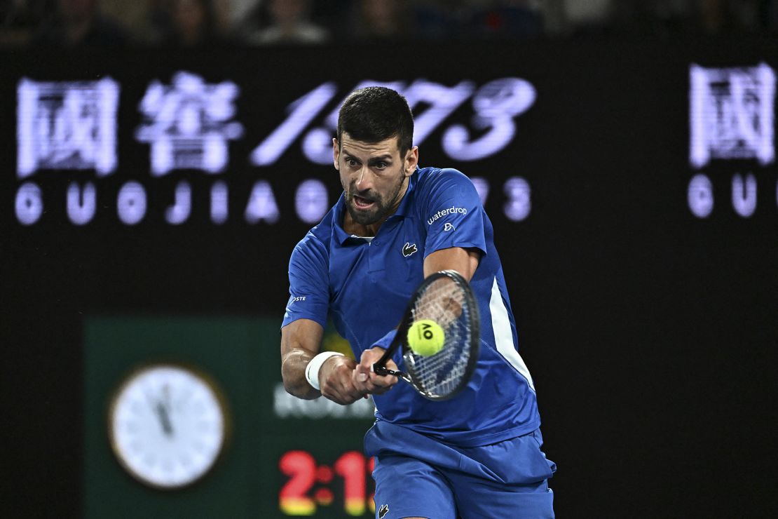 Serbia's Novak Djokovic hits a return against Australia's Alexei Popyrin during their men's singles match on day four of the Australian Open tennis tournament in Melbourne on January 17, 2024. (Photo by Lillian SUWANRUMPHA / AFP) / -- IMAGE RESTRICTED TO EDITORIAL USE - STRICTLY NO COMMERCIAL USE -- (Photo by LILLIAN SUWANRUMPHA/AFP via Getty Images)