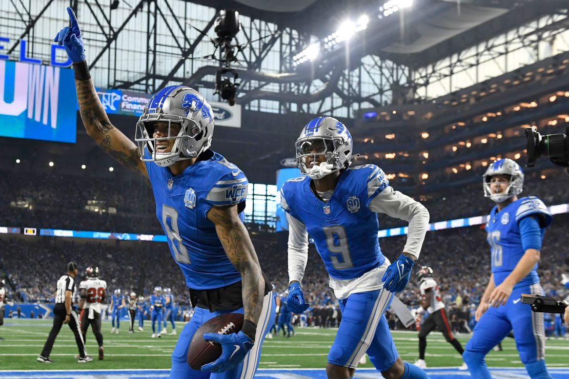 Detroit Lions wide receiver Josh Reynolds (8) celebrates with teammates Jameson Williams (9) and Jared Goff (16) after scoring a touchdown against the Tampa Bay Buccaneers during the first half of an NFL football NFC divisional playoff game, Sunday, Jan. 21, 2024, in Detroit. (AP Photo/Jose Juarez)