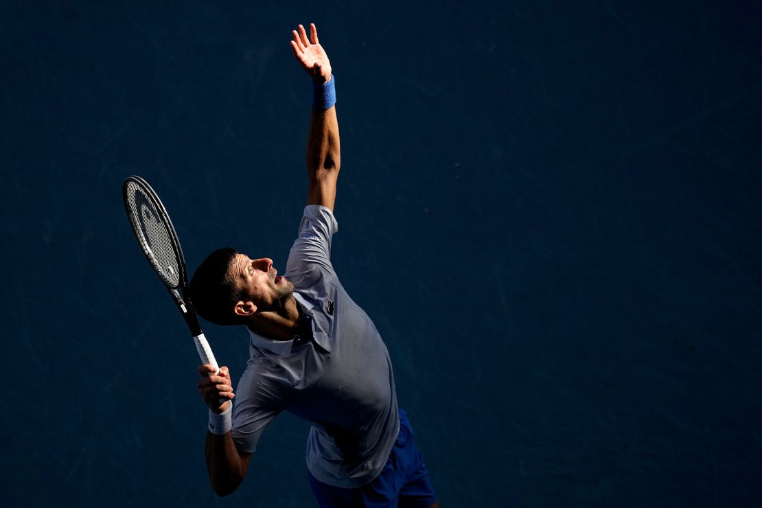 Novak Djokovic of Serbia serves to Jannik Sinner of Italy during their semifinal at the Australian Open tennis championships at Melbourne Park, Melbourne, Australia, Friday, Jan. 26, 2024.