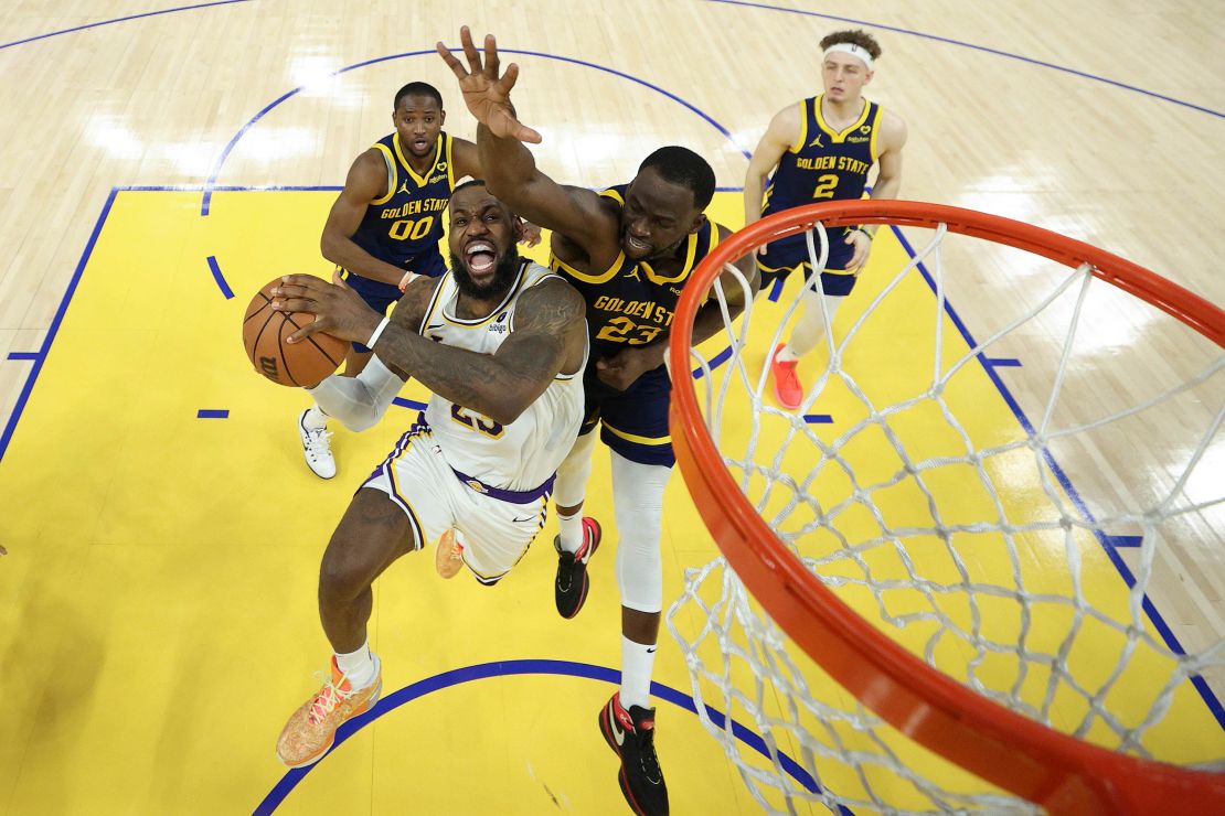 SAN FRANCISCO, CALIFORNIA - JANUARY 27: LeBron James #23 of the Los Angeles Lakers is fouled by Draymond Green #23 of the Golden State Warriors with one second left in double overtime at Chase Center on January 27, 2024 in San Francisco, California. James made both of the free throws and the Lakers won by one point. NOTE TO USER: User expressly acknowledges and agrees that, by downloading and or using this photograph, User is consenting to the terms and conditions of the Getty Images License Agreement.  (Photo by Ezra Shaw/Getty Images)