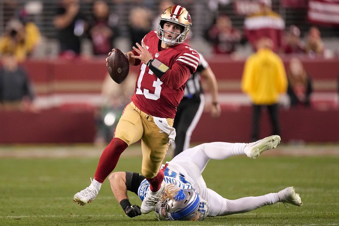 San Francisco 49ers quarterback Brock Purdy (13) runs against Detroit Lions linebacker Alex Anzalone during the second half of the NFC Championship NFL football game in Santa Clara, Calif., Sunday, January 28, 2024.