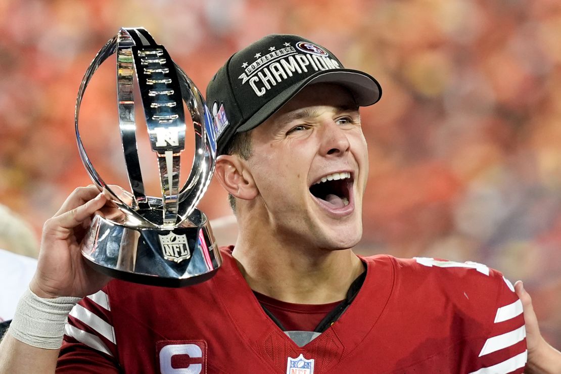 San Francisco 49ers quarterback Brock Purdy celebrates with the trophy after their win against the Detroit Lions in the NFC Championship NFL football game in Santa Clara, Calif., Sunday, January 28, 2024.