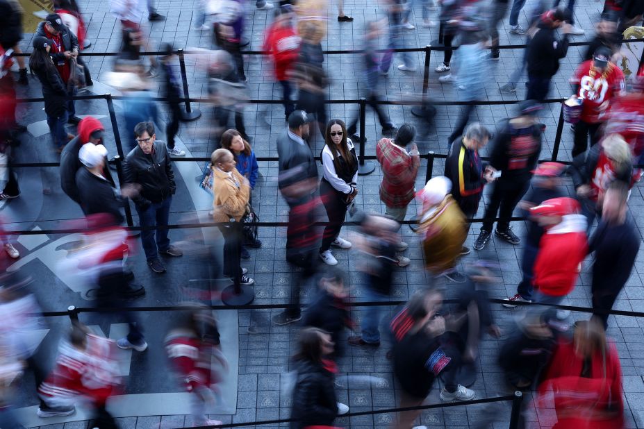 Fans line up outside the stadium before the game.