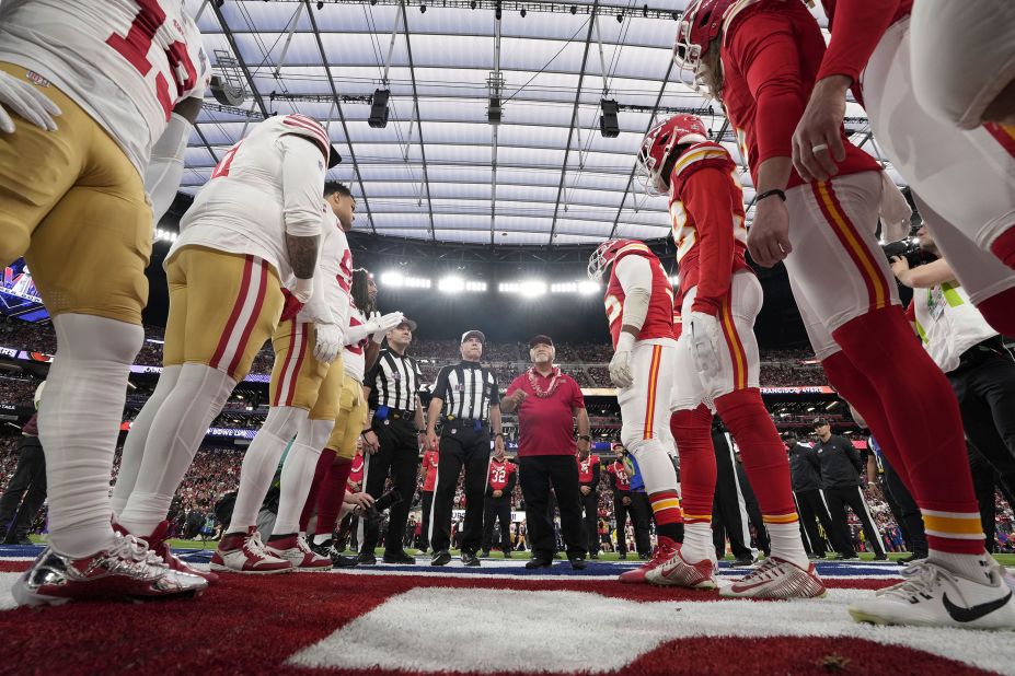 Team captains line up for the pregame coin toss.