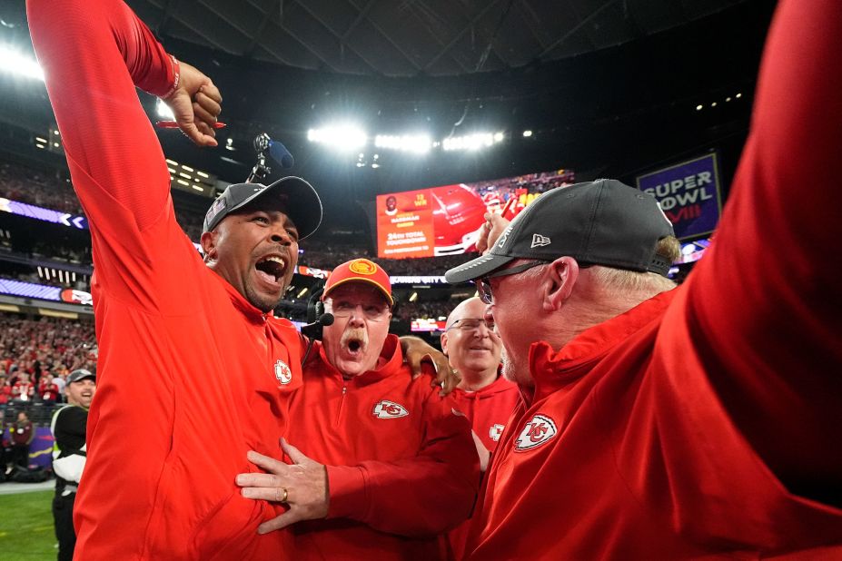 Chiefs head coach Andy Reid, second left, celebrates with staff members after the game.