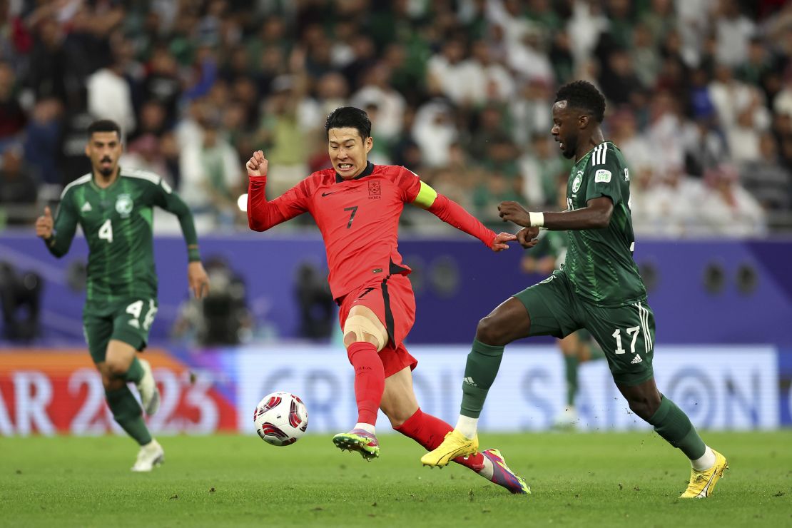 Hassan Tambakti of Saudi Arabia and South Korea captain Son Heung-Min battle for the ball.