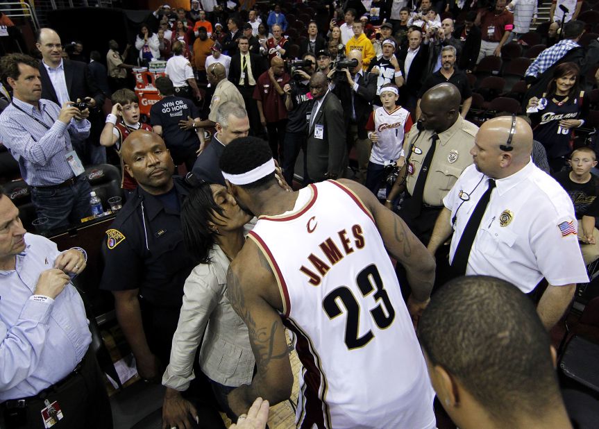 James gets a kiss from his mother after a playoff game in May 2010.