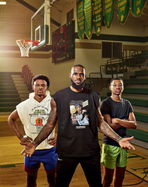 James poses with his two sons — Bronny, left, and Bryce — at his former high school in Akron in July 2022. Bronny was one of the best high school players in the country, and his dad said he wants to finish his career by playing with him in the NBA.