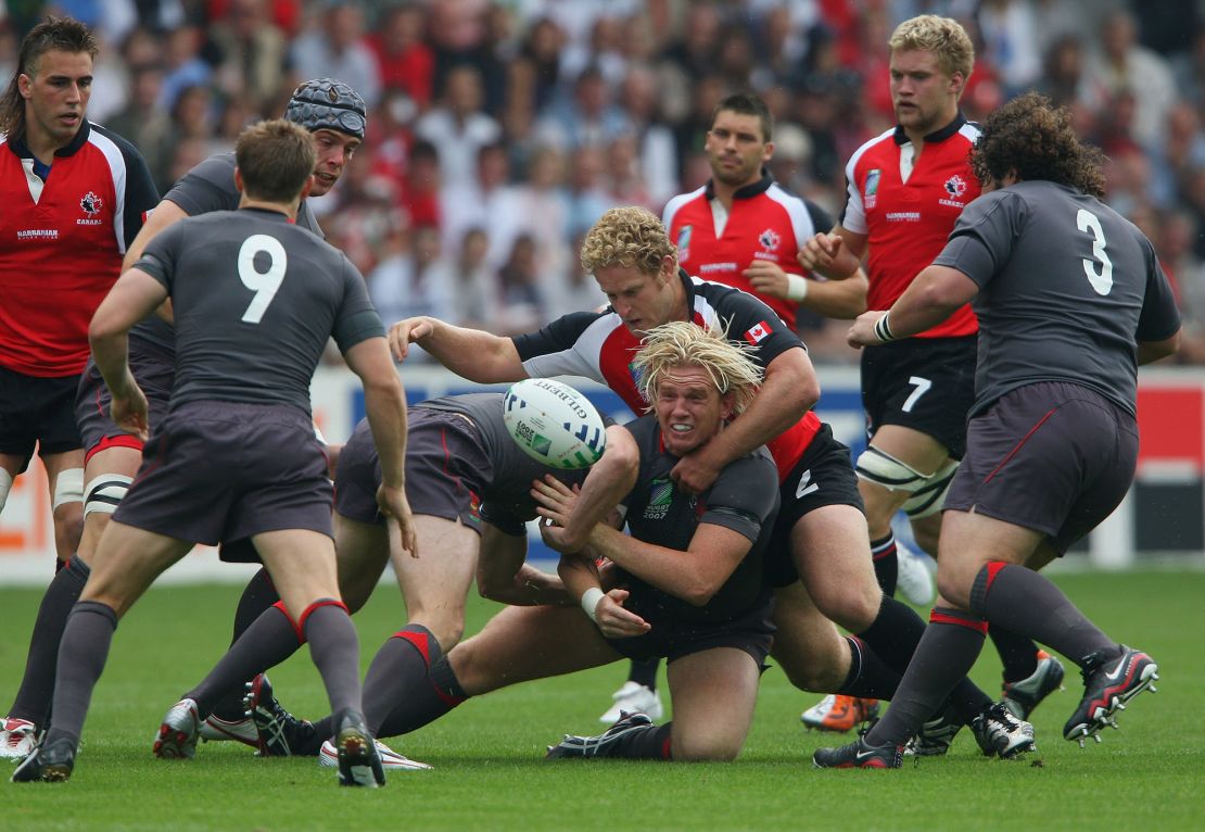 NANTES, FRANCE - SEPTEMBER 09:  Alix Popham of Wales offloads as he is wrapped up by Pat Riordan of Canada during the Rugby World Cup 2007 Pool B match between Wales and Canada at the Stade de la Beaujoire on September 9, 2007 in Nantes, France.  (Photo by Stu Forster/Getty Images)