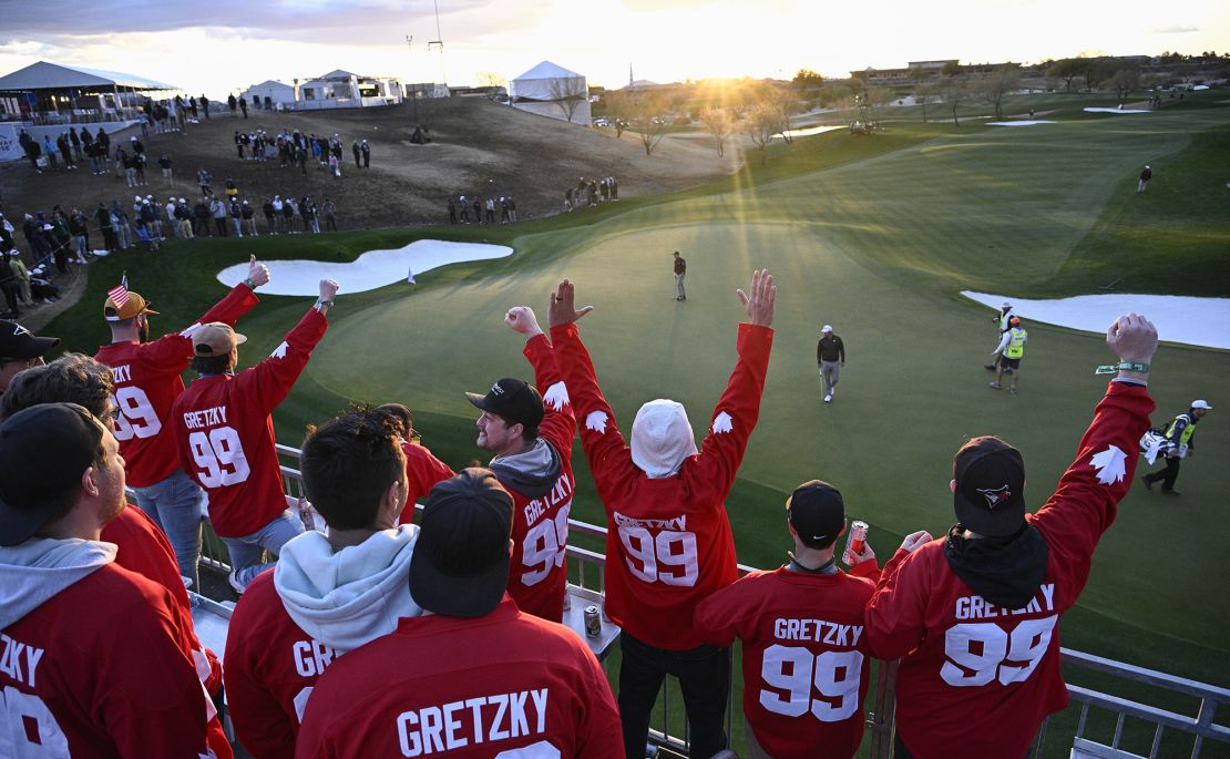 Fans donning "Gretzky" jerseys cheer on Canada's Taylor during the third round.