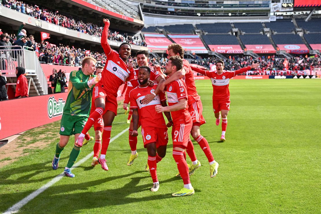 Acosta is mobbed by his Fire teammates after completing the turnaround.