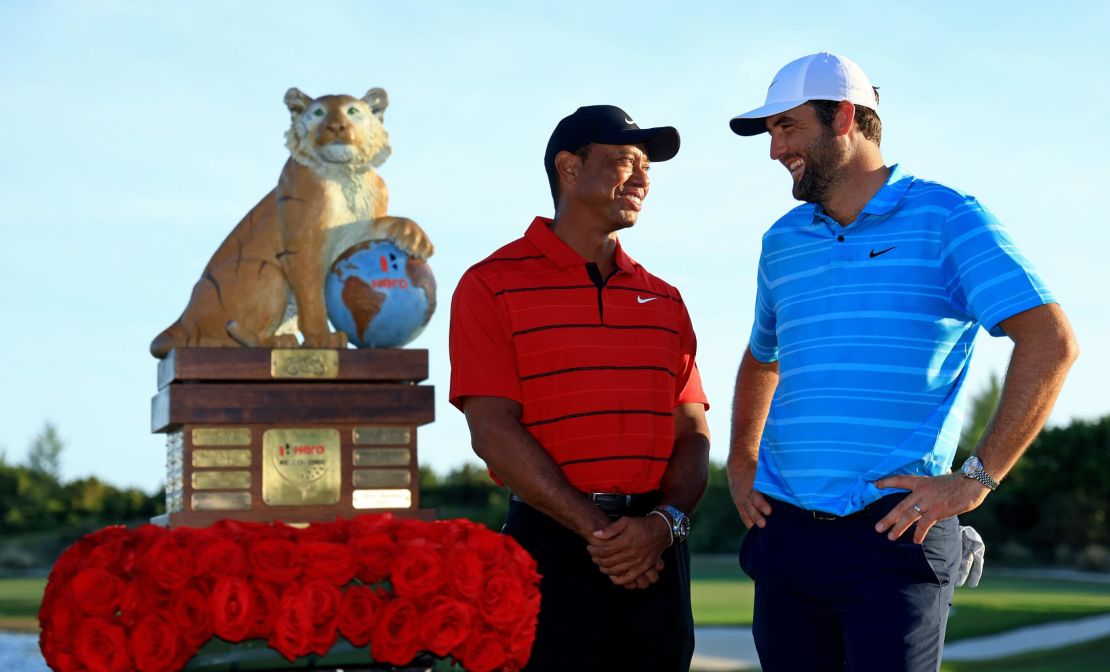 NASSAU, BAHAMAS - DECEMBER 03: Scottie Scheffler of the United States and tournament host Tiger Woods pose with the trophy after winning the final round of the Hero World Challenge at Albany Golf Course on December 03, 2023 in Nassau, . (Photo by Mike Ehrmann/Getty Images,)