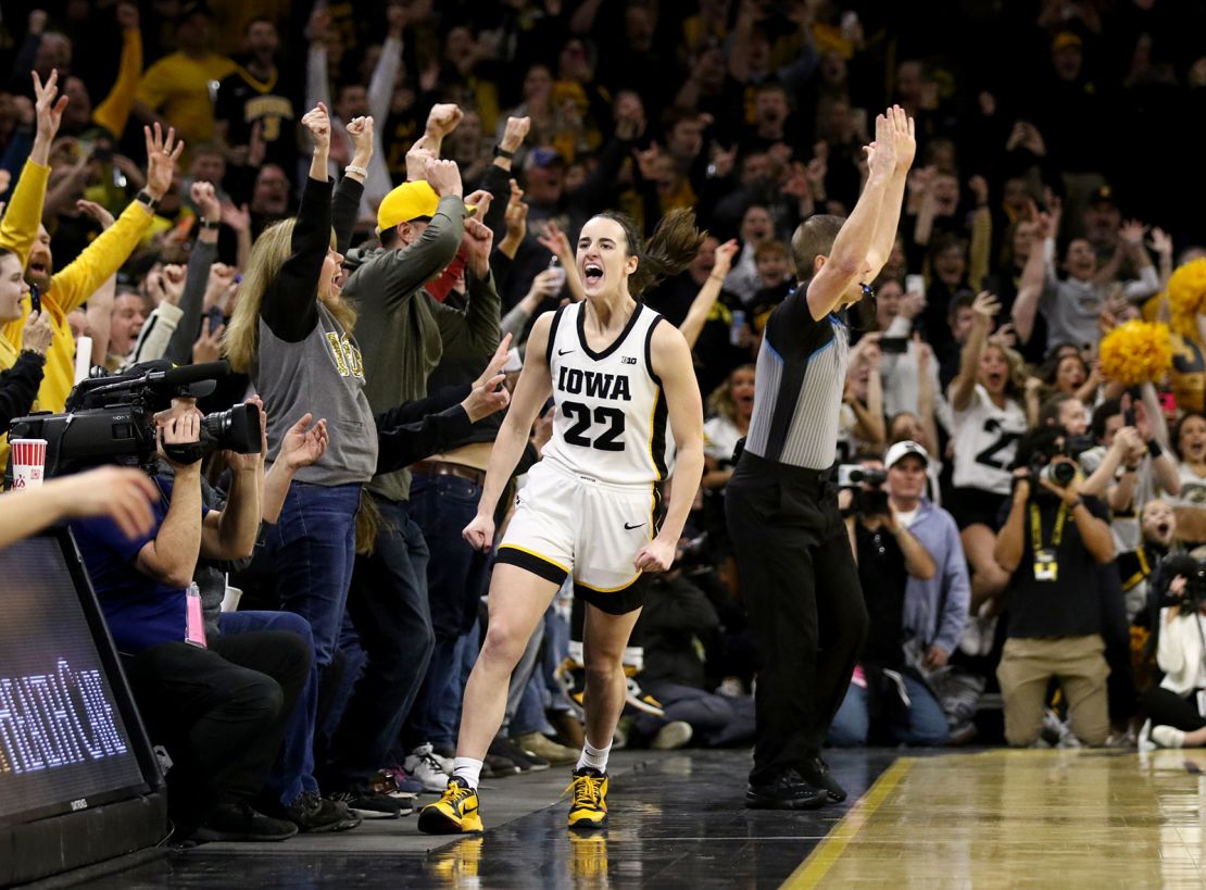 IOWA CITY, IOWA- FEBRUARY 15:  Guard Caitlin Clark #22 of the Iowa Hawkeyes celebrates after breaking the NCAA women's all-time scoring record during the first half against the Michigan Wolverines  at Carver-Hawkeye Arena on February 15, 2024 in Iowa City, Iowa.  (Photo by Matthew Holst/Getty Images)