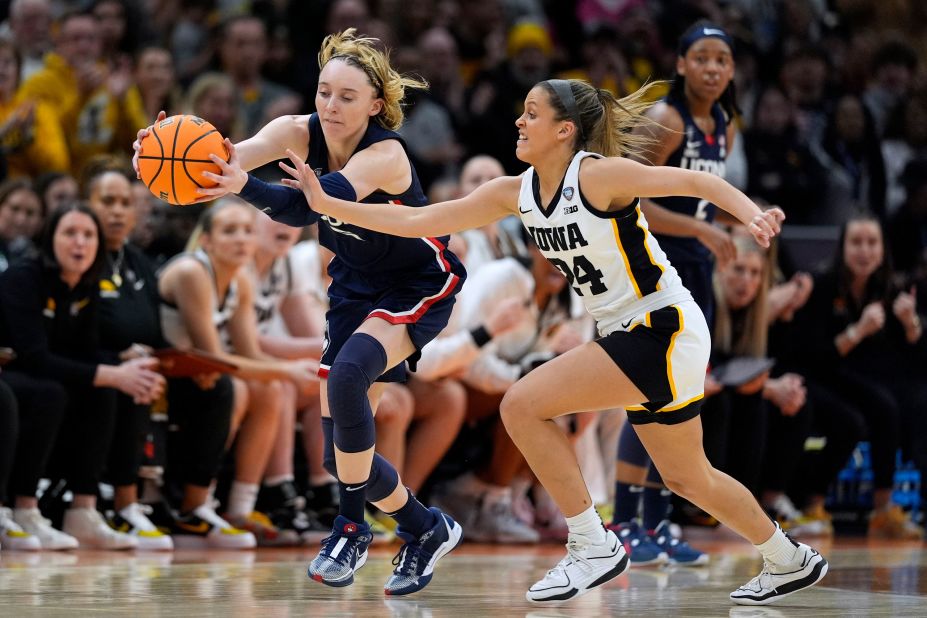 Bueckers fights for a loose ball with Iowa guard Gabbie Marshall during the first half. The Huskies held a 32-26 lead at halftime.