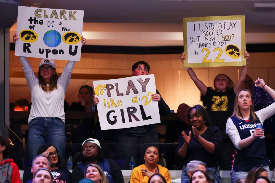 Iowa Hawkeyes fans hold up signs during the game.