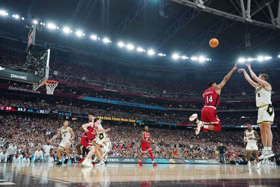 Loyer shoots over NC State guard Casey Morsell.