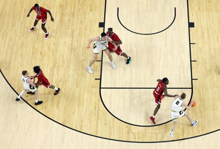 Loyer dribbles the ball toward the basket.