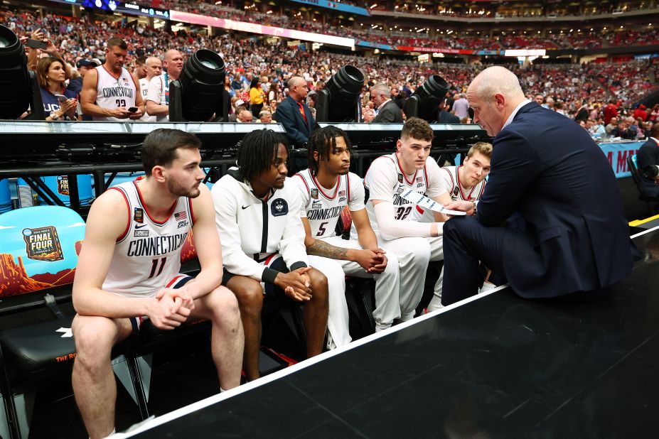 Hurley talks to the team during player introductions before the game.