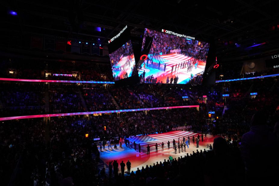 Players stand for the national anthem ahead of the game.