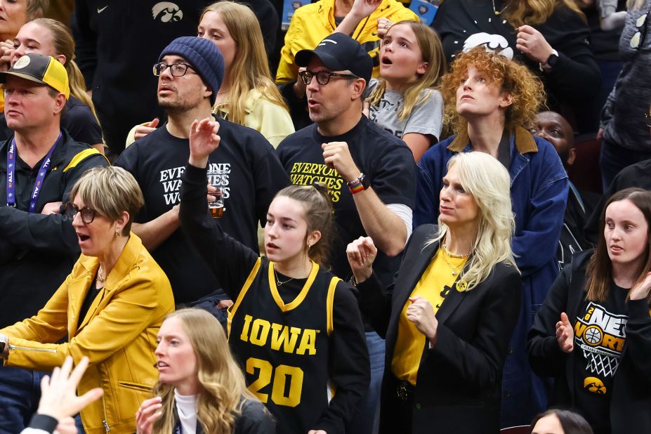 Actor Jason Sudeikis, center, watches the game.