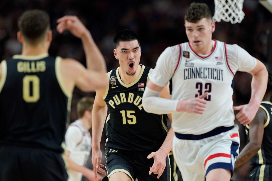 Purdue's Zach Edey runs up court with UConn's Donovan Clingan.