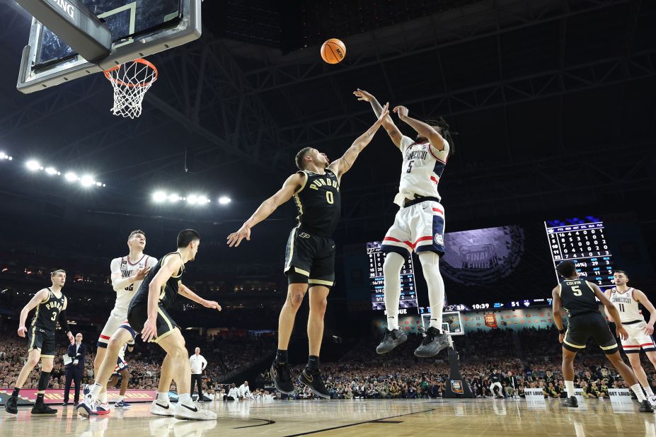 UConn's Stephon Castle attempts a shot while being guarded by Purdue's Mason Gillis.