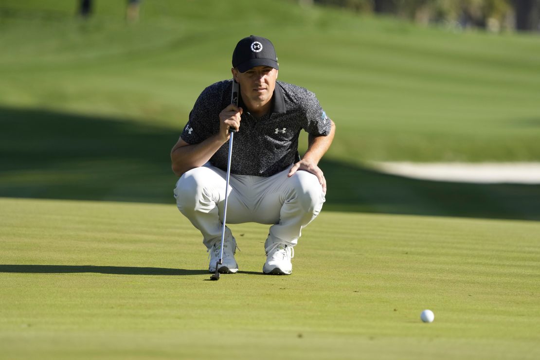 Spieth lines up a putt during the first round.