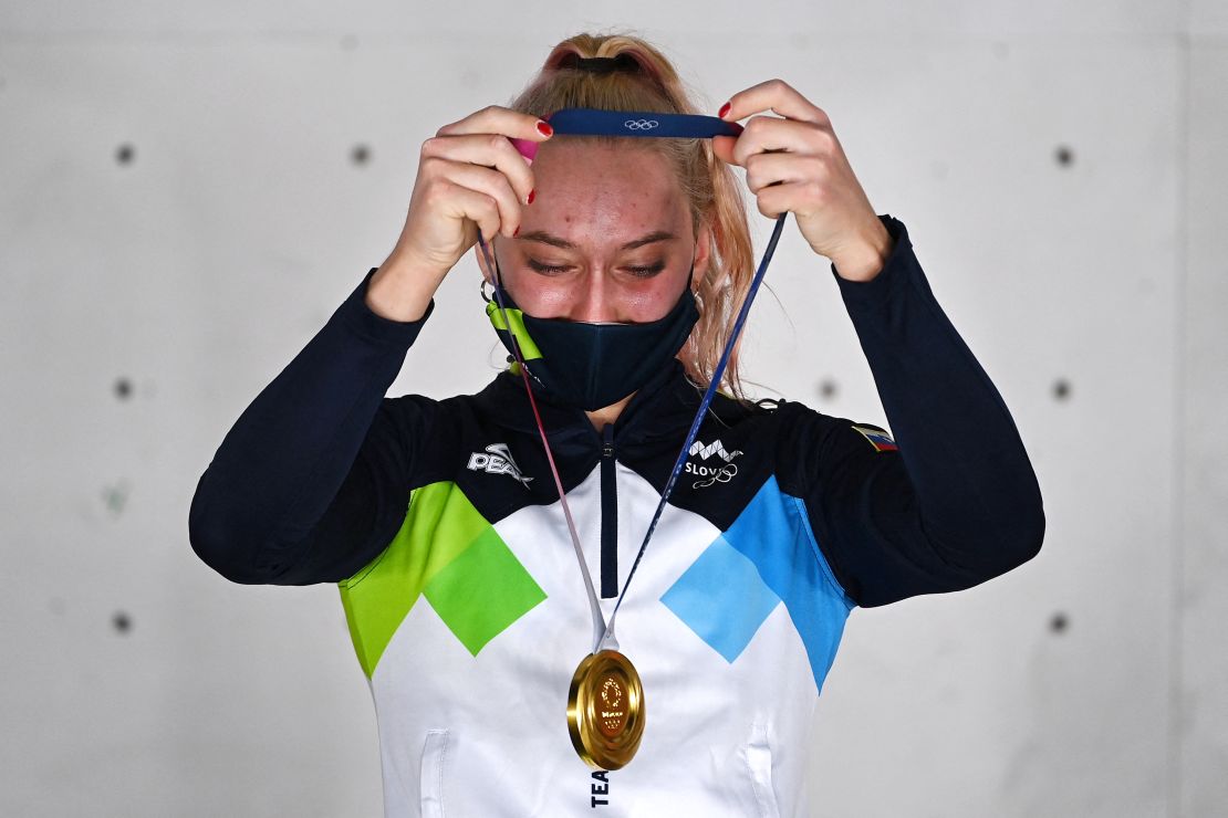 Garnbret celebrates on the podium after winning gold at Tokyo 2020.