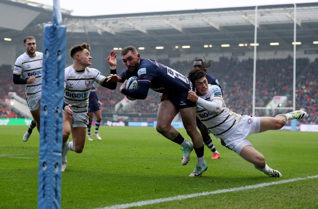 Rees-Zammit makes a tackle while playing for Gloucester.