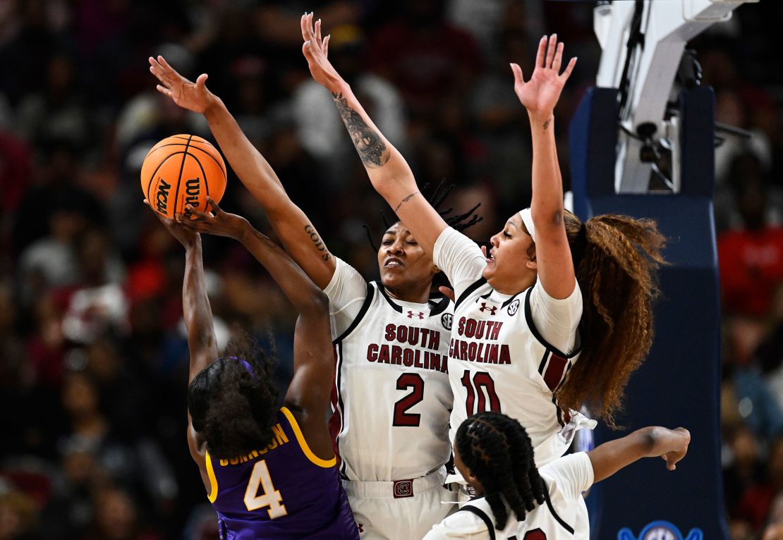 Ashlyn Watkins #2 and Kamilla Cardoso #10 of the South Carolina Gamecocks block a shot attempt by Flau'jae Johnson #4 of the LSU Lady Tigers in the fourth quarter during the championship game of the SEC Women's Basketball Tournament at Bon Secours Wellness Arena on March 10 in Greenville, South Carolina.