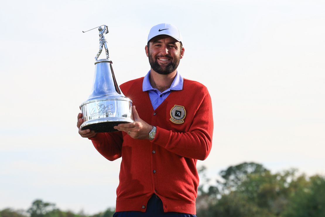 Scheffler poses with the trophy.