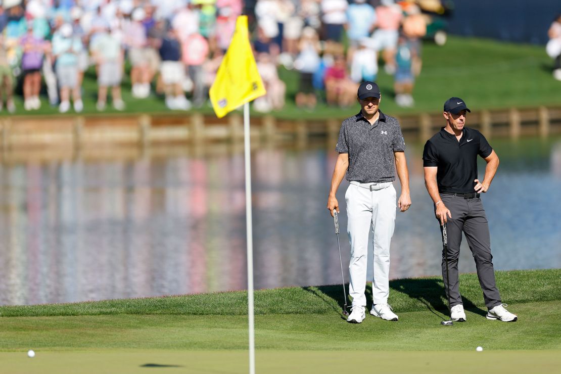 Spieth [left] and McIlroy look on at the 16th green.