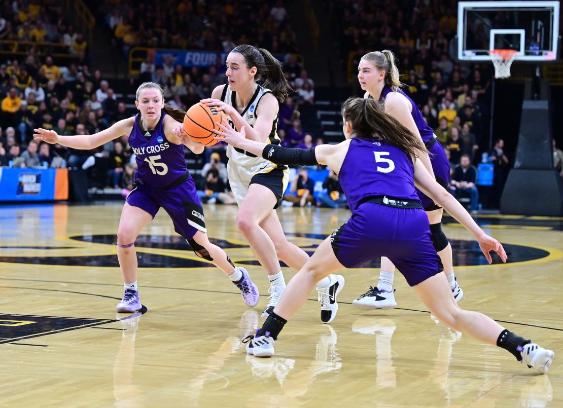 Clark drives to the basket against Holy Cross defenders.