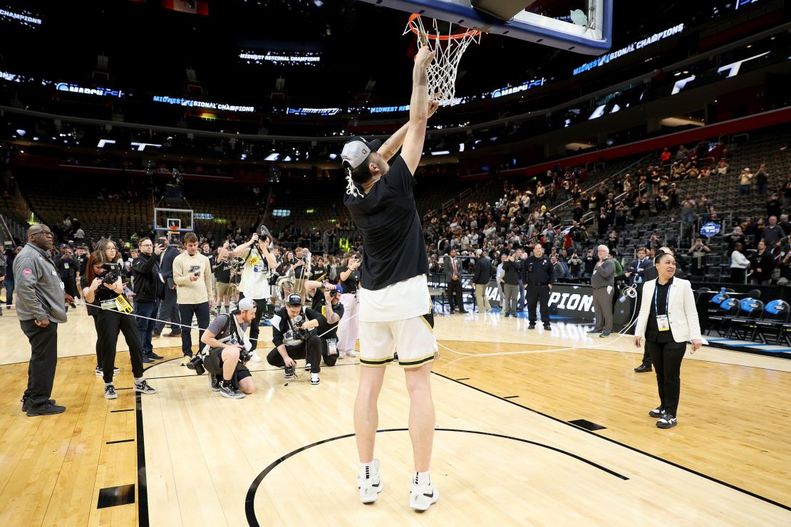 Zach Edey of Purdue cuts down the net after defeating the Tennessee Volunteers in the Elite 8.