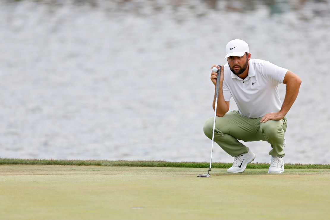 Scheffler lines up a putt on the 18th green during his final round.