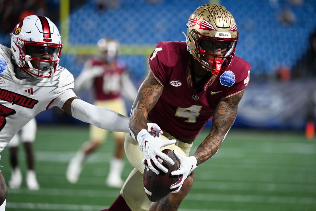 Dec 2, 2023; Charlotte, NC, USA; Florida State Seminoles wide receiver Keon Coleman (4) makes a catch against the Louisville Cardinals in the second quarter at Bank of America Stadium. Mandatory Credit: Bob Donnan-USA TODAY Sports